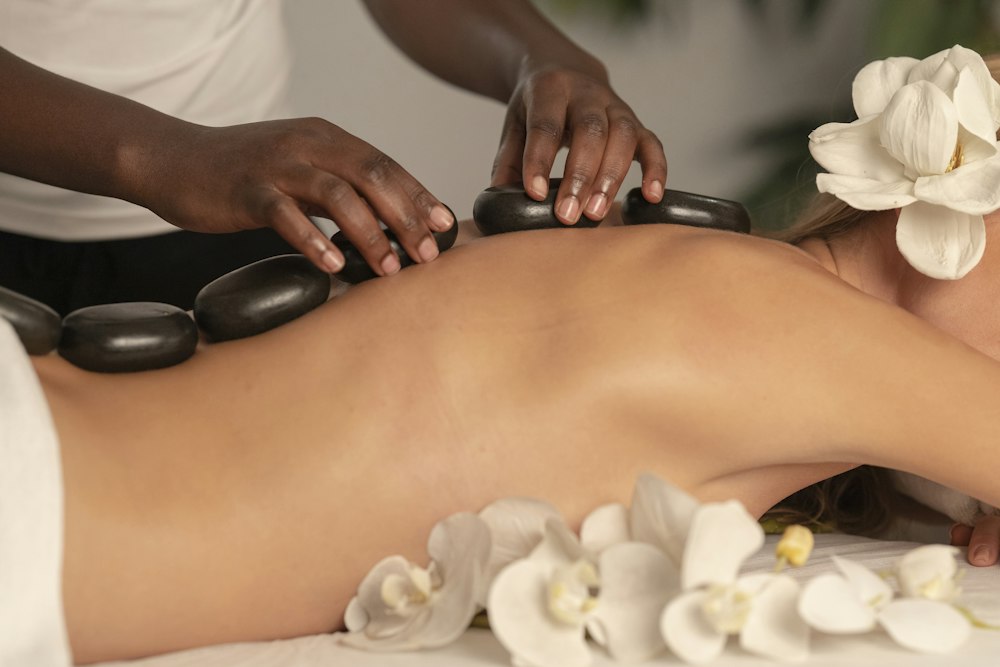 Hot stones on a client’s back at a spa