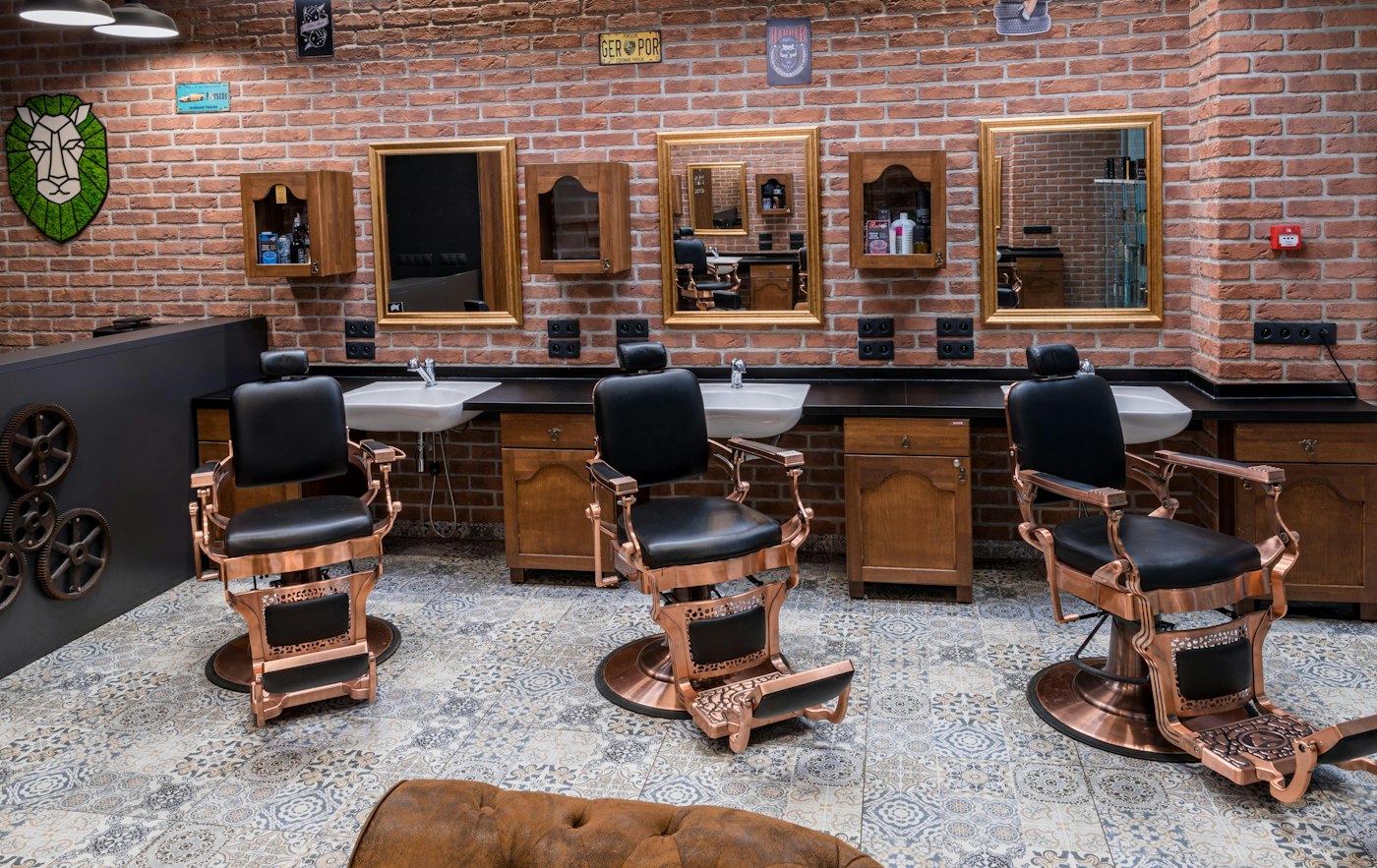 A barbershop with a row of empty chairs